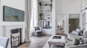 a living room with a fireplace with a tv above it at 2-4 bedroom 2 roof terraces prime Notting Hill in London