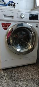 a washing machine sitting on top of a counter at Matosinhos -Seas Apartment- Cabo das Marés in Matosinhos