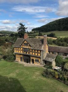 an aerial view of a large house in a field at Lavender Cottage, 3 School Road, Clun, Shropshire in Clun