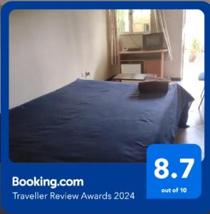 a bedroom with a bed with a blue blanket at Wib Guesthouse in Addis Ababa