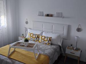 a bedroom with a bed with a table on it at Benalbeach Holidays Benalmâdena in Benalmádena