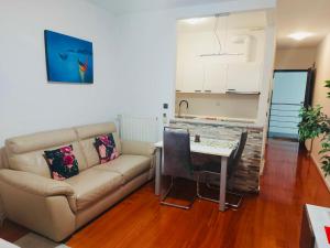 a living room with a couch and a table at Nova Galerija West App MARY - parking in garage in Zagreb