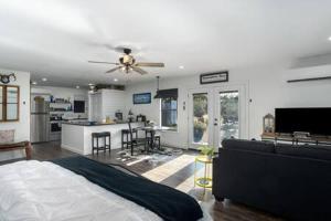 a bedroom with a bed and a living room with a kitchen at A Nest For Two, Bathhouse, Firepit, Sleeps 2 in Fredericksburg +34 photos