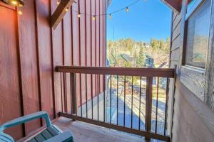 a balcony with a blue chair and a window at Modern 3 BDR Heart of Downtown Walk Everywhere in Breckenridge