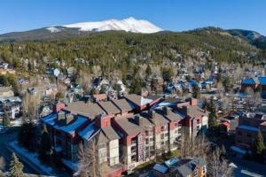 an aerial view of a building with a mountain in the background at Modern 3 BDR Heart of Downtown Walk Everywhere in Breckenridge
