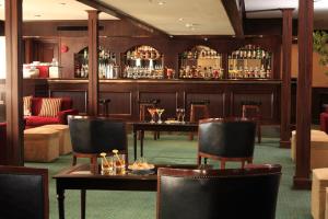 a restaurant with tables and chairs and a bar at Iberotel Helio Nile Cruise - Every Monday from Luxor for 07 & 04 Nights - Every Friday From Aswan for 03 Nights in Luxor +3 photos