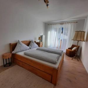 a bedroom with a large bed in a room at Ferienhaus-Ferienwohnung Weitblick mit Garten und malerischem Bergpanorama in Oberammergau