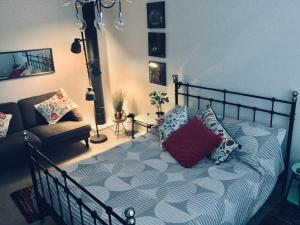 a bedroom with a bed with pillows and a couch at Firbank House in Glenrothes