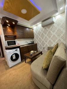 a living room with a couch and a kitchen at al-burj apart 7th circle in Amman