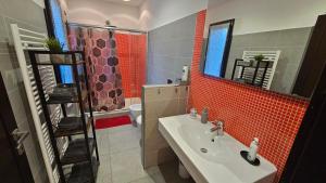 a bathroom with a sink and a toilet and a mirror at AK Homes, a due passi da Orio in Azzano San Paolo +37 photos