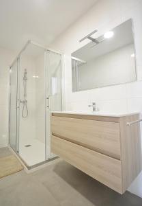 a bathroom with a shower and a sink and a mirror at Apartamento con vistas en Playa de As Sinas in Villanueva de Arosa +11 photos