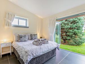a bedroom with a bed and a large window at 1 Bed in Blairgowrie 93427 in Rattray