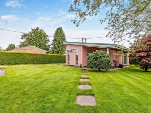 a pink house with a lawn in front of it at 1 Bed in Blairgowrie 93427 in Rattray
