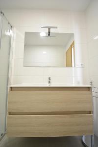 a bathroom with a sink and a mirror at Apartamento con vistas en Playa de As Sinas in Villanueva de Arosa