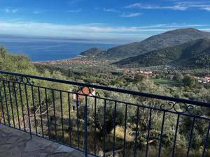 a view of the ocean from a balcony at Maison de vacances pour 6 personnes in Tyros +58 photos