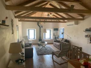 a living room with a couch and a table at Maison de vacances pour 6 personnes in Tyros