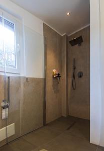 a shower with a glass door in a bathroom at Casa Calma in Pino Lago Maggiore