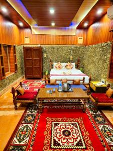 a bedroom with a bed and a red rug at Afno Ghar Temple Resort in Dhangarhi