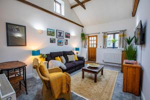 a living room with a couch and a table at The Carriage House a relaxing 1-Bed Cottage in Ash in Ash