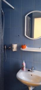 a blue bathroom with a sink and a mirror at Agroturystyka U Baltazara in Duszniki Zdrój
