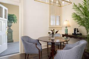 a dining room with a table and chairs at The Jasmine House in Charleston