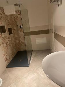 a bathroom with a shower with a glass door at L'obiettivo in Assemini +33 photos