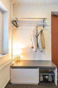 a closet with a table and two towels hanging on the wall at The Mäkkylä Escape - Perfect for 2 with sauna look and optional Hot Tub in Helsinki