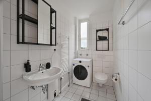 a white bathroom with a sink and a toilet at Goodliving Apartments mit Netflix Büro und Parkplatz in Essen
