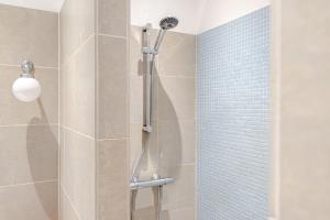 a shower with a shower head in a bathroom at Luxurious Family Home Amstelveen in Amstelveen