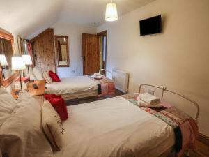 a hotel room with two beds and a tv at The Barn in Saltburn-by-the-Sea