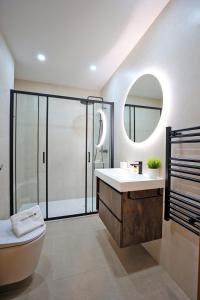 a bathroom with a toilet and a sink and a mirror at B90 - Casa Sardinha in Lagos in Lagos