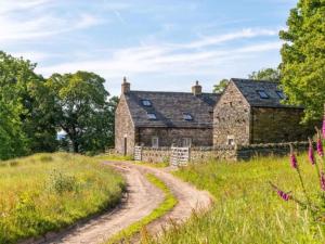 an old stone house with a dirt road in front at 3 Bed in Askham 93429 in Askham