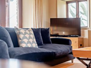 a blue couch in a living room with a flat screen tv at 3 Bed in Kirkby Stephen 93379 in Orton