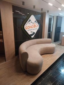 a circular chair in a lobby with a sign at Gondola Apartments in Jahorina
