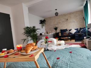 a living room with swans and bread on a bed at Romantic Cocon Home in Mulhouse in Mulhouse