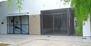 a gate on the side of a building at La Casa de Mirna in Formosa