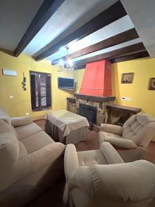 a living room with couches and a fire place at Casa Gomez in Gaucín