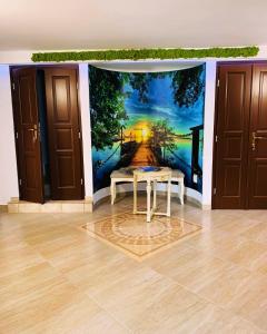a wall mural in a room with a table at Casa Lazar in Topliţa