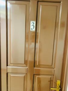 a door with a number three sign next to it at Casa Lazar in Topliţa