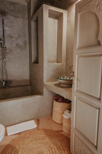 a bathroom with a shower and a toilet and a door at Riad 117 in Marrakech +67 photos