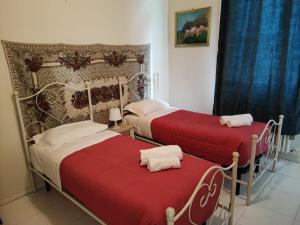 2 bedden met rode dekens in een kamer bij Venezia Gentile in Venetië