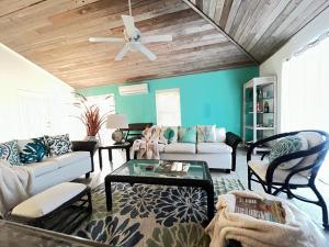 a living room with a couch and a ceiling fan at A'Viva Grace Bay - Alta3 in The Bight Settlements