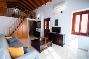 a living room with a couch and a table at YIAYIA's Central Apartment in Symi