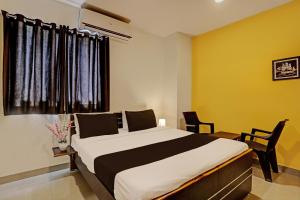 a bedroom with a large bed and a window at Hotel Saharsh Grand Near Shilparamam in Hyderabad