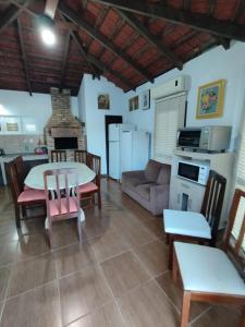 a living room with a table and a couch at Casa de praia com piscina para 10 pessoas in São Francisco do Sul