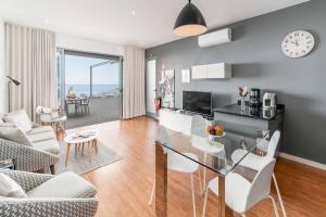 a kitchen and living room with a glass table at Villa da Portada in Funchal