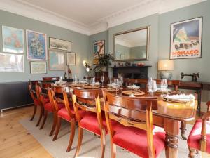 a dining room with a large wooden table and chairs at Mount Lebanon in Clevedon