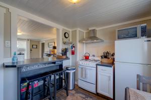 a kitchen with a white refrigerator and a stove at Akari Bungalow #5 in Long Beach