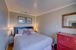 a bedroom with a white bed and a red dresser at Akari Bungalow #5 in Long Beach