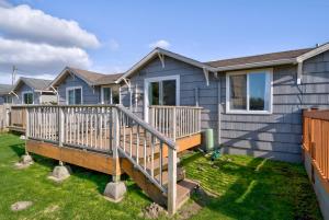 a blue house with a wooden deck in the yard at Akari Bungalow #5 in Long Beach